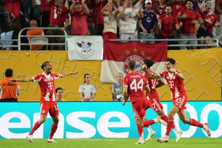 Michael Olise celebrates with Bayern Munich teammates after scoring a late goal