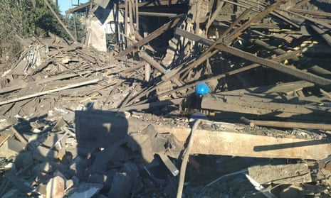 Rescuers work at the ruins of a residential building destroyed by a Russian military strike in Toretsk.