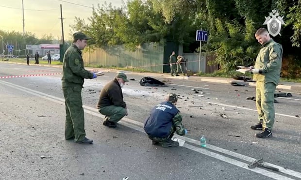Investigators work at the site of the suspected car bomb attack that killed Darya Dugina on the outskirts of Moscow.