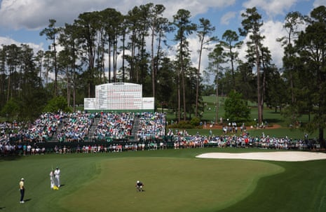 Rory McIlroy lines up his birdie putt on the green of the 15th.