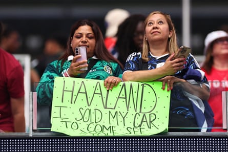 Two women with a sign saying ‘I sold my care to come see you.’