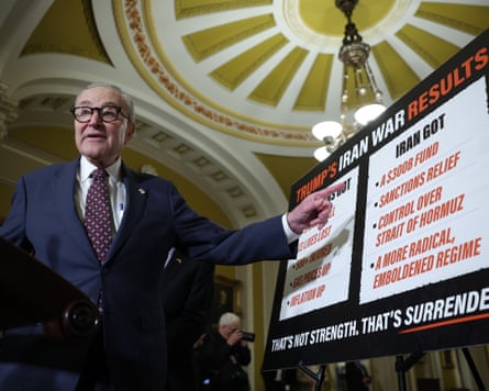 Chuck Schumer, the US Senate minority leader, speaks to reporters on Tuesday. He stands next to a board criticizing the details of Donald Trump’s memorandum of understanding with Iran.
