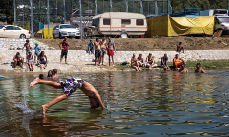 A boy dives into the Bjelica river in Guca, Serbia, 10 August 2017, as the Lucifer heatwave continues with temperatures in Serbia reaching 38C.