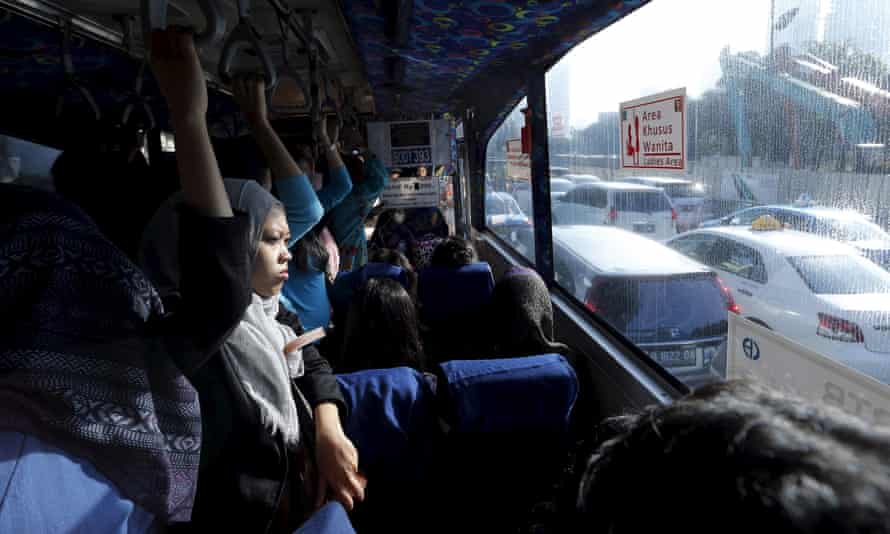 Passengers on a bus in Jakarta.