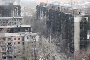 A view of damaged buildings and vehicles after shelling in the Ukrainian city of Mariupol.