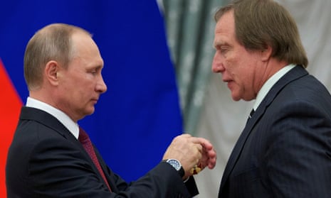 Vladimir Putin (left) awarding Sergei Roldugin during a ceremony at the Kremlin in 2016.