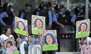Human rights activists take part in a protest following the murder of Berta Cáceres