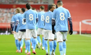 Manchester United v Manchester City - Carabao Cup Semi Final<br>MANCHESTER, ENGLAND - JANUARY 06: Manchester City players  walk out in tribute No 8 shirts in honor of Colin Bell prior to the Carabao Cup Semi Final match between Manchester United and Manchester City at Old Trafford on January 06, 2021 in Manchester, England. The match will be played without fans, behind closed doors as a Covid-19 precaution. (Photo by Matt McNulty - Manchester City/Manchester City FC via Getty Images)