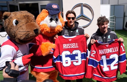 Mercedes’ George Russell and Mercedes’ Andrea Kimi Antonelli pose for a picture with the Montreal Canadiens mascot Youppi! and Canadian GP Mascot Vroum, a giant groundhog.