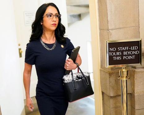 a woman walks in a corridor