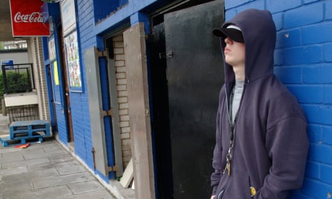 Young lad with hoody hanging around shops