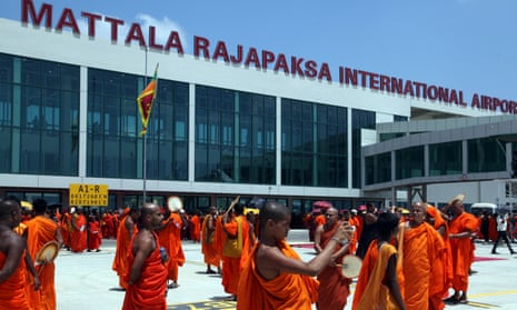 Sri Lankan monks take pictures at the opening of an airport built with Chinese money in Hambantota