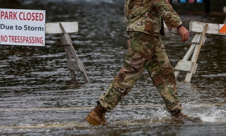 Soldier walks through flood waters