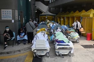 People in hospital beds outside medical centre