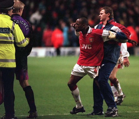 Gary Lewin holds back Ian Wright in an altercation with Peter Schmeichel.