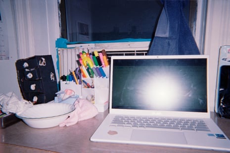 A view of of a desk with a laptop and various other stationery items.