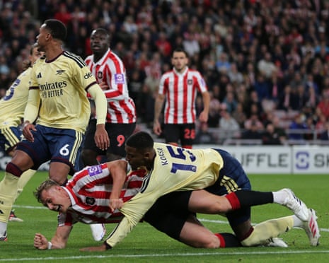 Arsenal's Ezri Konsa lands on top of Dan Ballard, leading to a Sunderland penalty
