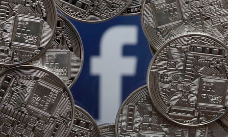 A visual representation of digital cryptocurrency coins sit on display in front of a Facebook logo