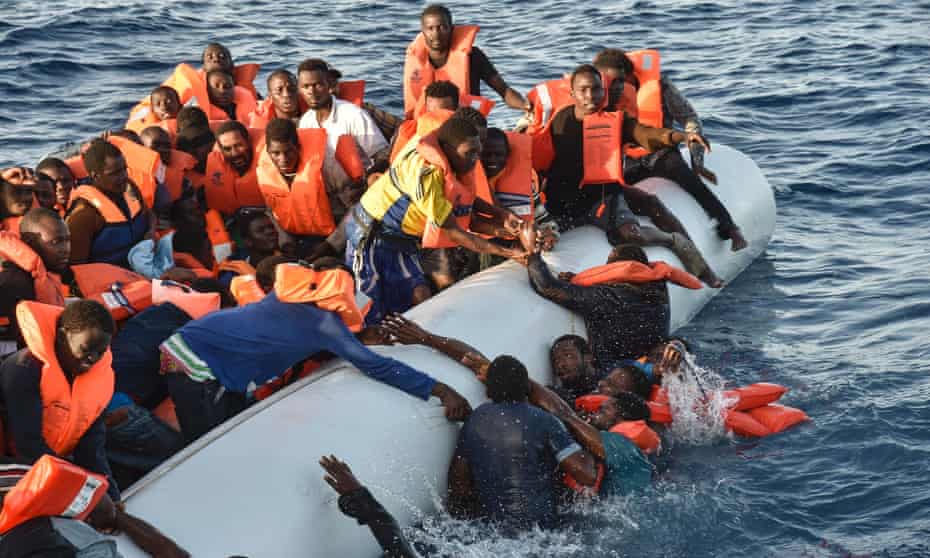 Scenes of panic as people fall in the water during a rescue operation by the Maltese NGO Moas and the Italian Red Cross off the Libyan coast on Thursday.