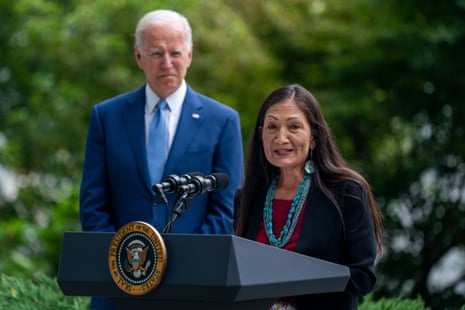 United States President Joe Biden looks on as US Secretary of the Interior Deb Haaland delivers remarks during a signing ceremony to restore and protect 3 national monuments on the North Lawn of the White House in Washington, DC.