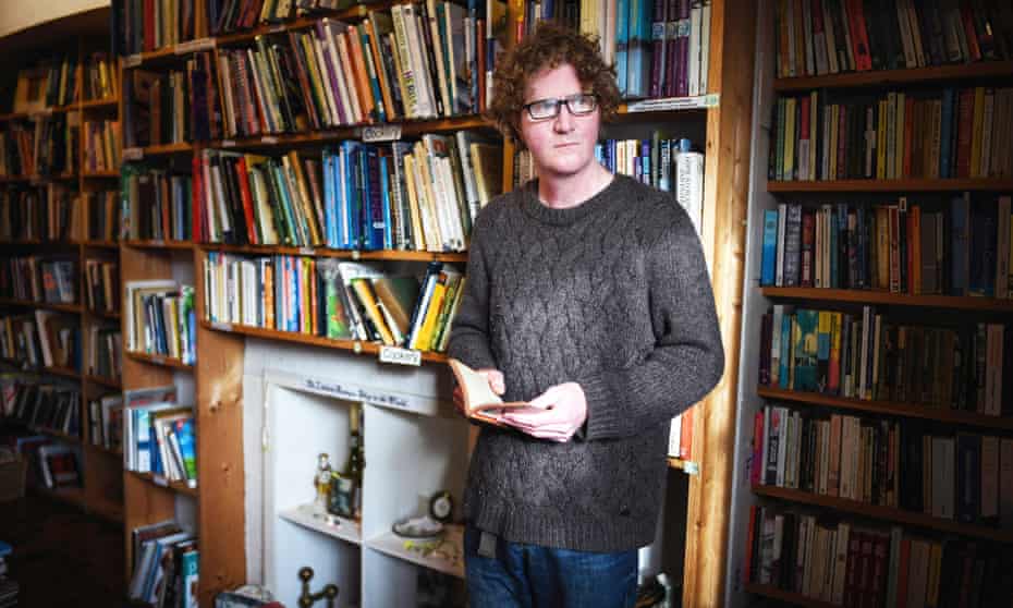 Parading his contemptus mundi … Shaun Bythell at his bookshop in Wigtown, Scotland.
