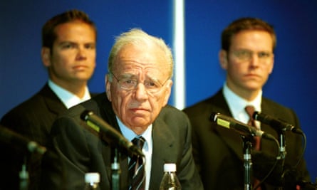 Rupert Murdoch, center, speaks to the media after the company’s annual general meeting in Adelaide, Australia, on October 9, 2002. He is flanked by his sons Lachlan Murdoch, left, and James Murdoch.