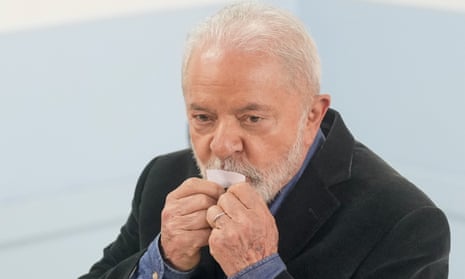 Former Brazilian president Luiz Inacio Lula da Silva kisses his ticket after voting in general elections in Sao Paulo.
