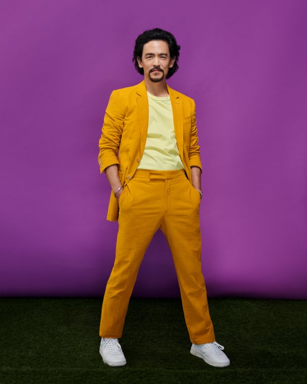 Bright spark: John Cho wears suit and T-shirt by Gabriela Hearst, and shoes by Greats.
