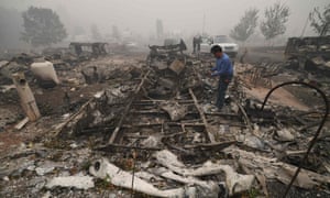 Marcelino Maceda looks for items in the remains of his mobile home in Estacada, Oregon.
