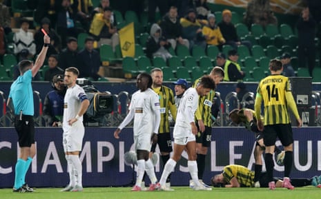 The referee shows João Correia a red card as players surround Luís Mata during the Champions League match between Kairat Almaty and Pafos