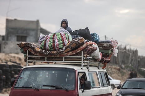 A van is pictured loaded with belongings on its roof and a Palestinian boy sat among the items. Palestinians have been leaving their homes and fleeing from Israel’s air, sea and land attacks in Khan Younis, Gaza on Tuesday.