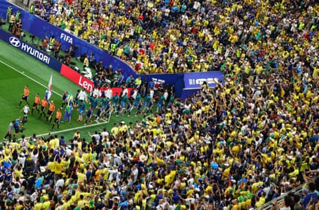 The teams walk out before the match.