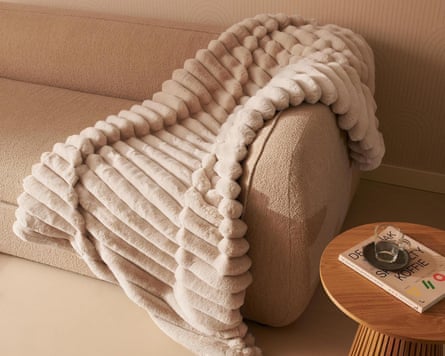 Duux heated overblanket on a sofa