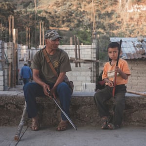 Mexico; Guerrero; Ayahualtempa; 2020 Member of the indigenous community police CRC-PF, with a child who’s joining the self-defence group in response to criminal group violence.