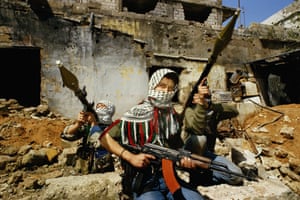Boys armed with AK-47s and RPGs at Burj al-Barajneh refugee camp