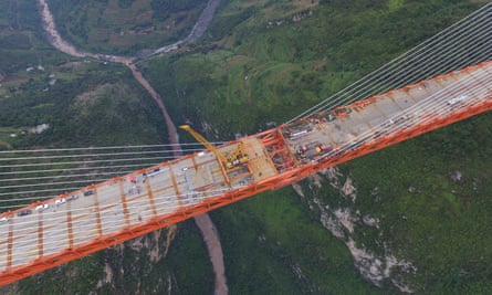 An aerial view shows workers completing the bridge that connects two provinces in Bijie.