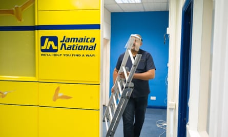 A shop staff member clears out the office of Jamaica National as shopping centre prepares to close its door for the final time.