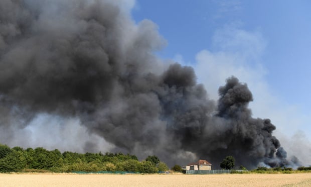 A fire burns during the heatwave in east London, on Tuesday.
