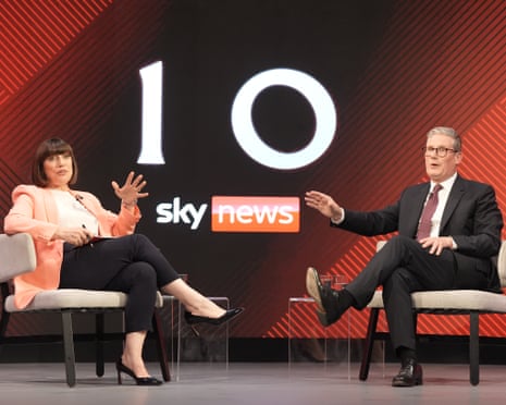 Rigby and Starmer sitting in chairs next to each other during interview