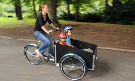 A family cargo bike on the move through the Berlin Zoo district. The bikes are subsidised by some 20 German cities and three states.