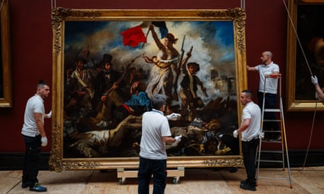 Employees of the Louvre Museum hang the restored painting of Liberty Leading the People