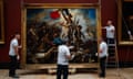 Employees of the Louvre Museum hang the painting "Liberty Leading the People"