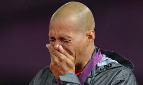 Dominican Republic's gold medalist Felix Sanchez cries on the podium of the men's 400m hurdles at the athletics event of the London 2012 Olympic Games