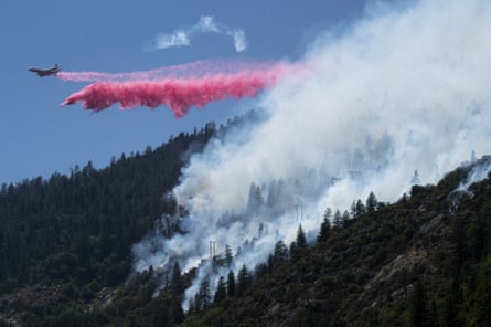 An air tanker drops fire retardant to battle the Dixie Fire in the Feather River canyon.