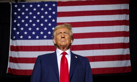 a man standing in front of America flag