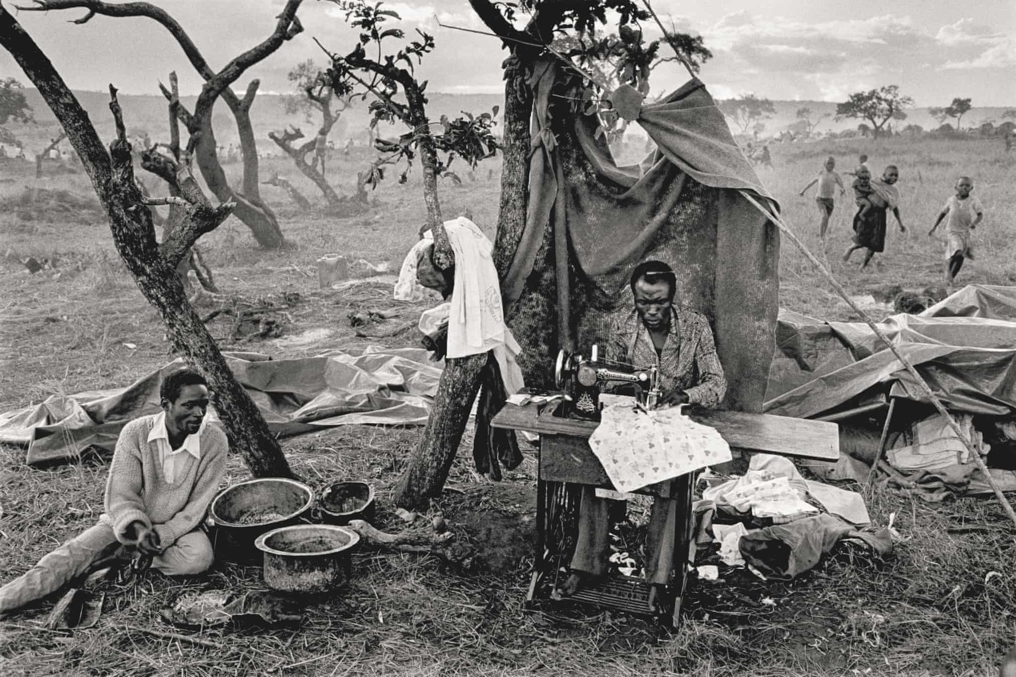 A tailor in the Rosumo Camp, working on a sewing machine transported from Rwanda on a bike. Ngara, Tanzania, 1994