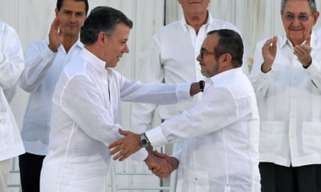Colombian president Juan Manuel Santos, left, and Farc leader Timochenko shake hands during the signing of the historic peace agreement in Cartagena on Monday.