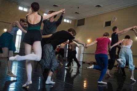 A troupe of ballet dancers rehearse.