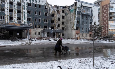A woman walks past a building damaged by a Russian military strike, amid Russia's attack on Ukraine, in the town of Pokrovsk in Donetsk region, Ukraine 12 December 2024.