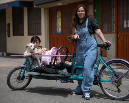 Eliana Gónzalez rides around her neighbourhood on her cargo bike with her infant, teenage son, and dog.